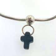 Sterling silver bracelet with one silver bead and a grey/black cross charm