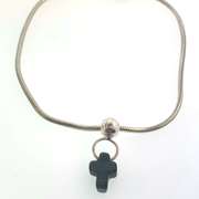 Sterling silver bracelet with one silver bead and a grey/black cross charm