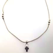 Sterling silver necklace with a purple cross charm and silver beads