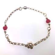Sterling silver bracelet with pink heart beads and a flower charm