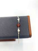 Sterling silver bracelet with orange & silver star charms