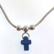 Sterling silver bracelet with three silver beads and one blue cross charm