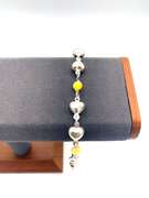 Sterling silver bracelet with yellow beads and silver heart charms