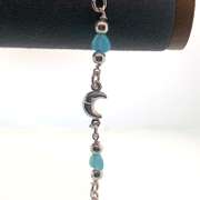 Sterling silver bracelet with light blue heart charms and silver moon and round bead charms.