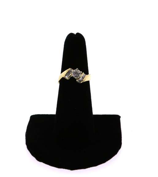Large Diamond Ring Flanked by Baguette Diamond on a 14k Gold Band