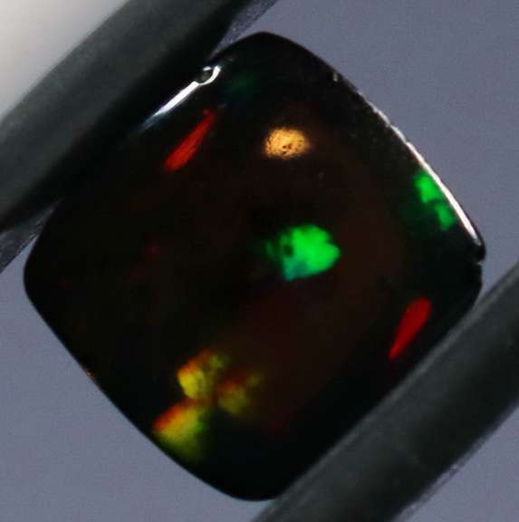Magnificent 1.74ct pinfire flashing Black Opal