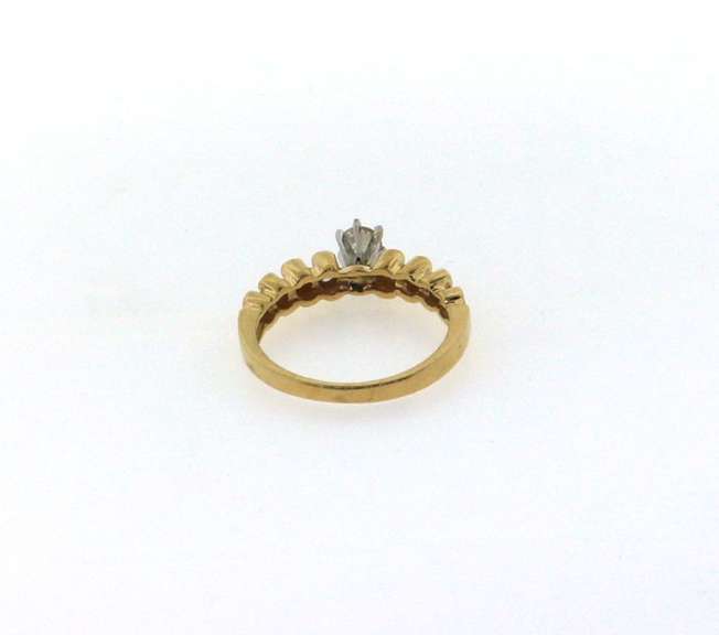 Solitaire Diamond Ring with Round side stones and a 14k Gold Band