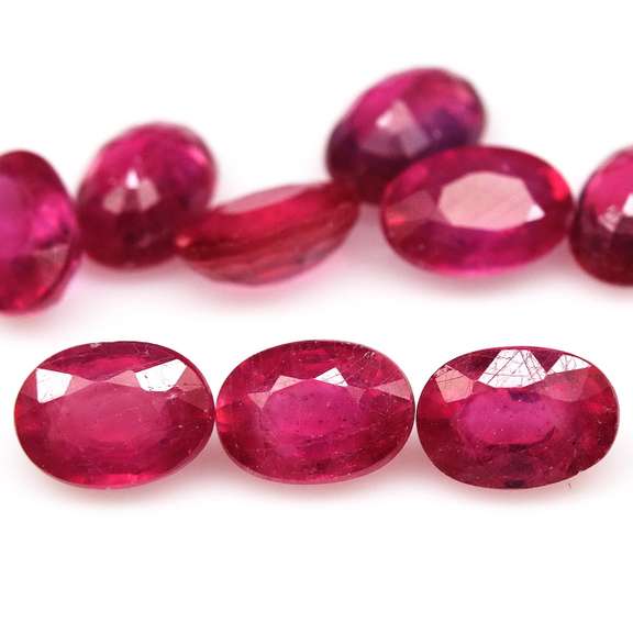 Vibrant 10.88ct oval cut reddish pink Ruby set