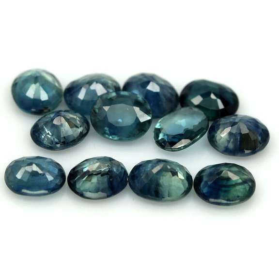 Heated only! 9.09ct blue green Sapphire set