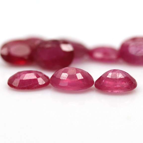 Vibrant 9.73ct oval cut reddish pink Ruby set