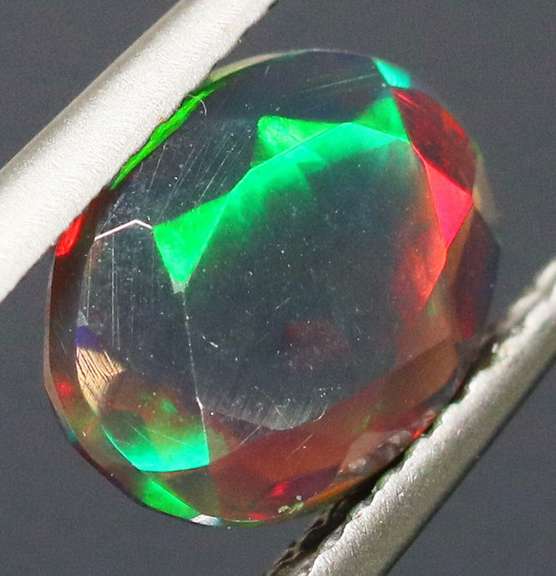 Fully faceted full panel flashing 1.55ct oval cut Black Opal