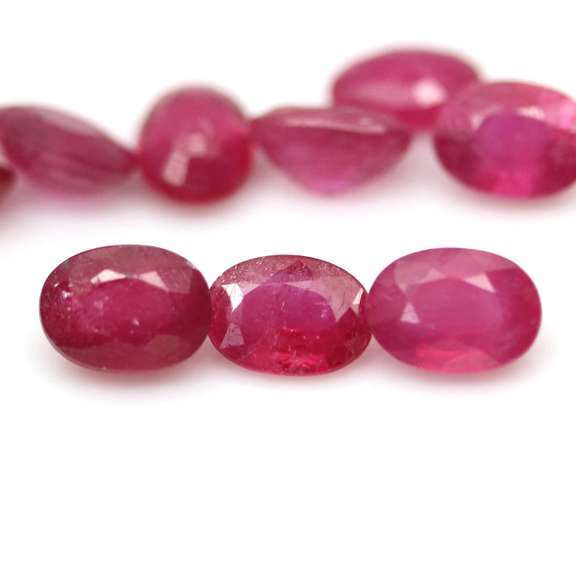 Vibrant 9.73ct oval cut reddish pink Ruby set