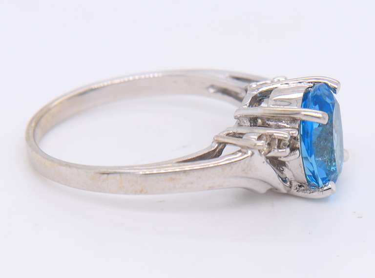 Handsome White Gold Oval Blue Topaz and Diamond Ring