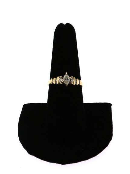Oval Diamond Ring beset by Baguette Diamonds on a 14k Gold Band