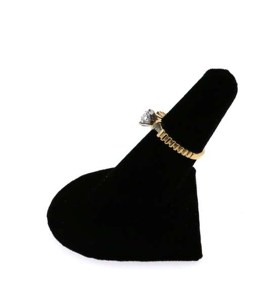 Brilliant Oval Diamond Ring flanked by Baguette Diamonds on a 14k Gold Band