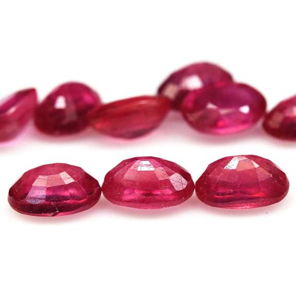 Vibrant 10.88ct oval cut reddish pink Ruby set