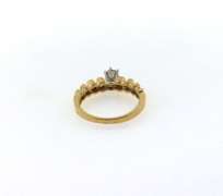Solitaire Diamond Ring with Round side stones and a 14k Gold Band