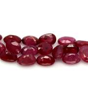 Vibrant 12.75ct oval cut imperial red Ruby set