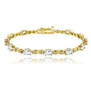 Yellow Gold Flashed Sterling Silver Blue Topaz 6x4mm Oval Infinity Bracelet with White Topaz Accents