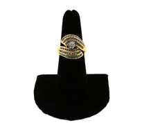 Phenominal Round Diamond Centerpiece clutched by triple row Channel Set Diamonds on a 14k Gold Band