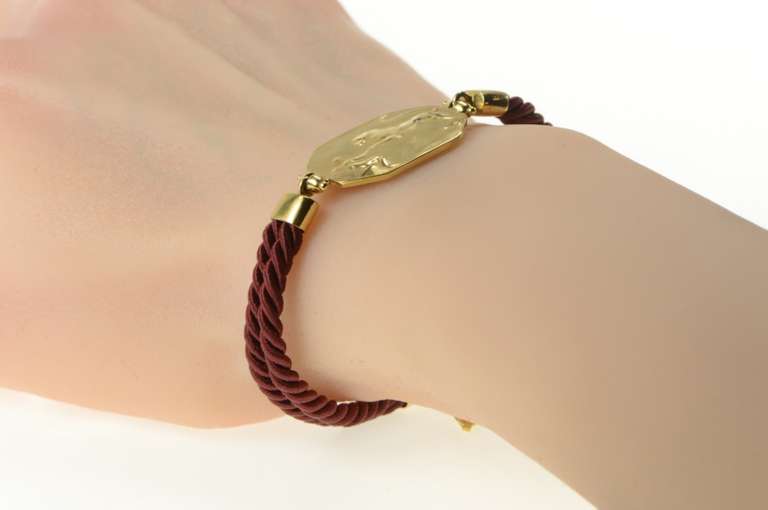 14K Yellow Gold Lion & Man Scene Burdick Co. Burgundy Cord Bracelet