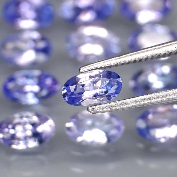 Heavy flashing 4.61ct oval cut Tanzanite set