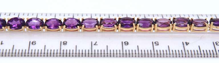 Stunning Yellow Gold oval Amethyst Tennis Bracelet
