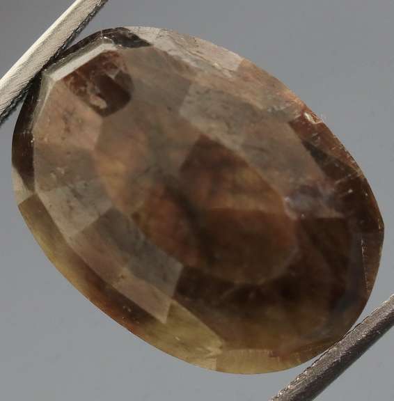 Golden shimmering 15.17ct earth toned faceted Sapphire