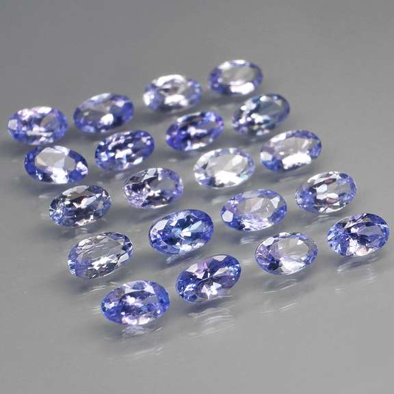 Heavy flashing 4.61ct oval cut Tanzanite set