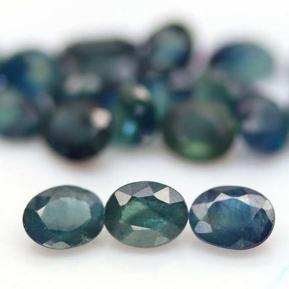 Heated only! 9.56ct blue green Sapphire set