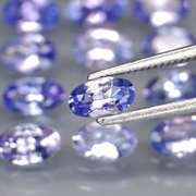 Heavy flashing 4.61ct oval cut Tanzanite set