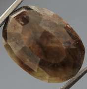 Golden shimmering 15.17ct earth toned faceted Sapphire