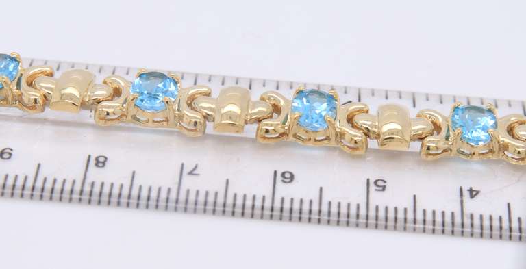 Powerful Yellow Gold oval Blue Topaz X Station Bracelet