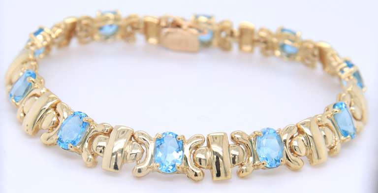 Powerful Yellow Gold oval Blue Topaz X Station Bracelet