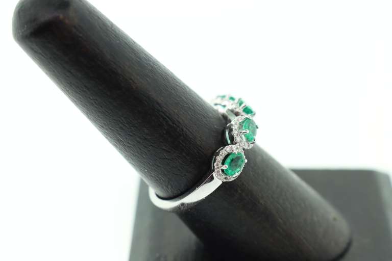 Mesmerizing Four-Stone Emerald 18k White Gold Ring edged with Diamonds