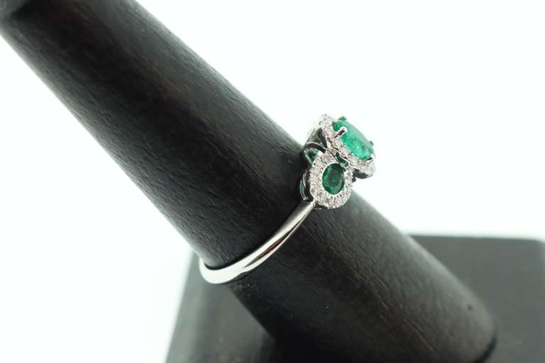 Beautiful Three-Stone Emerald 18k White Gold Ring edged with Sparkling Diamonds