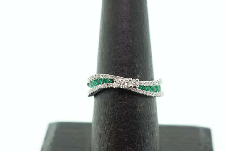 Flowing Channel Set 18k White Gold Emerald and Diamond Ring with Triple-Stone Center