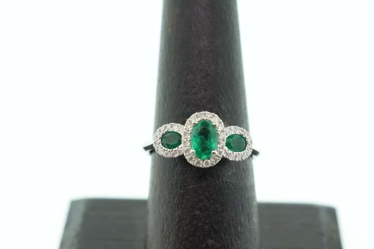 Beautiful Three-Stone Emerald 18k White Gold Ring edged with Sparkling Diamonds