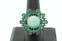 Mesmerizing Opal Ring surrounded by Emeralds and Diamond Accents
