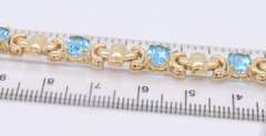Powerful Yellow Gold oval Blue Topaz X Station Bracelet