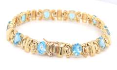 Powerful Yellow Gold oval Blue Topaz X Station Bracelet