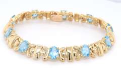 Powerful Yellow Gold oval Blue Topaz X Station Bracelet