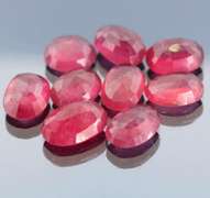 Vibrant 42.97ct oval cut reddish pink Ruby set