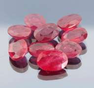 Vibrant 42.97ct oval cut reddish pink Ruby set