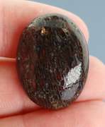 Multi toned 25.16ct cabochon cut from dinosaur bone