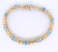 Powerful Yellow Gold oval Blue Topaz X Station Bracelet