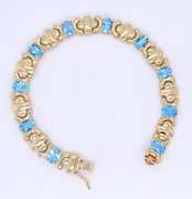 Powerful Yellow Gold oval Blue Topaz X Station Bracelet
