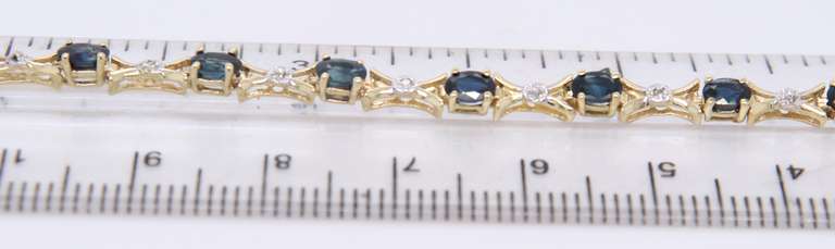 Fantastic Yellow Gold Oval Blue Sapphire and Diamond X Bracelet