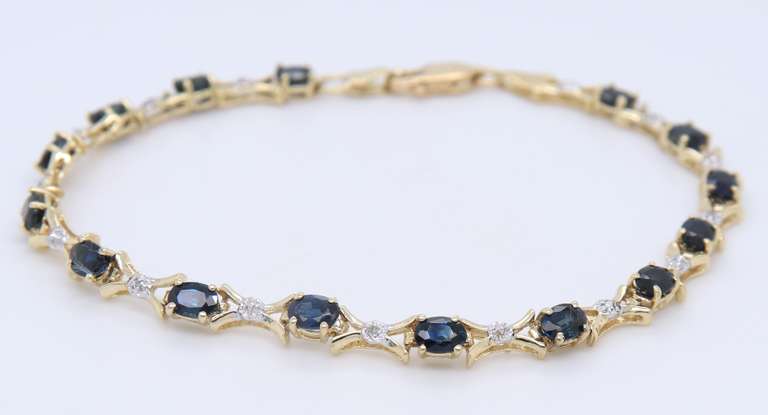 Fantastic Yellow Gold Oval Blue Sapphire and Diamond X Bracelet