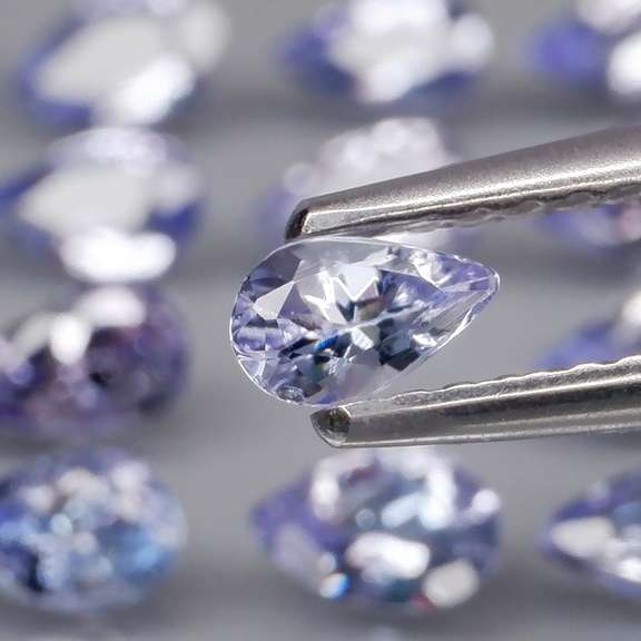 Heavy flashing 3.24ct pear cut Tanzanite set
